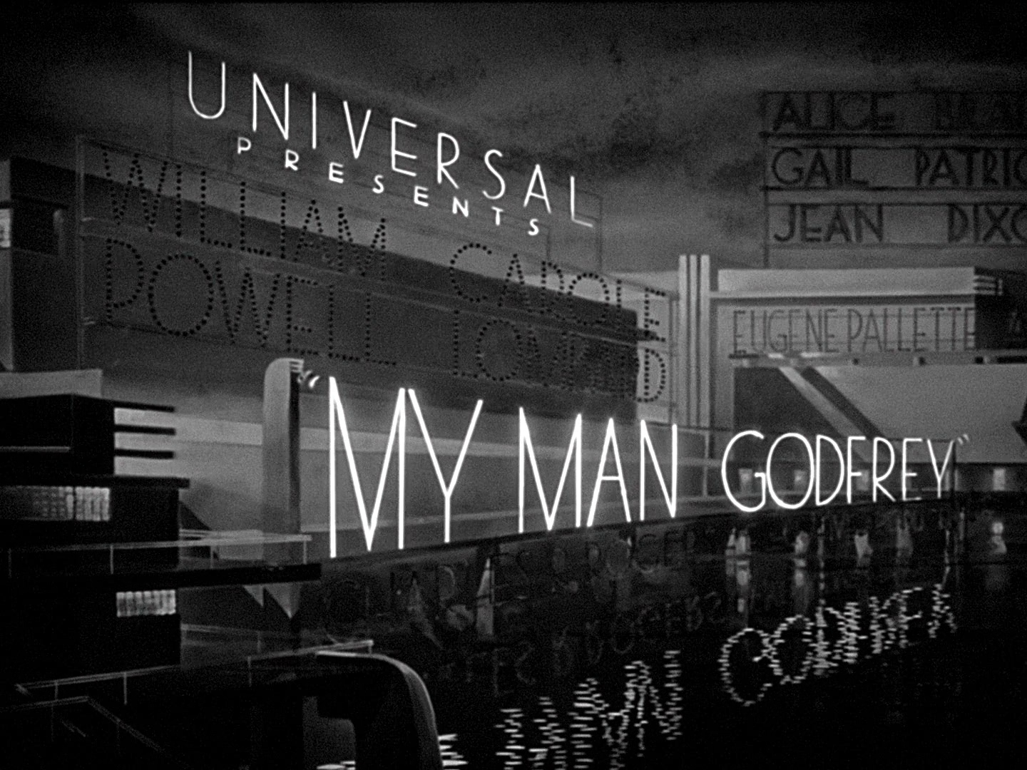 A matte painting of a set of neon signs reading "UNIVERSAL PRESENTS "MY MAN GODFREY." The neon is reflected in water below the signs; unlit signs with the cast members names are visible, waiting to be illuminated.
